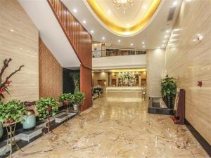 a lobby of a hotel with potted plants at Vienna Hotel Fuzhou Linchuan Avenue in Fuzhou