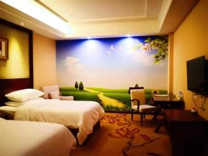 a hotel room with two beds and a painting on the wall at Vienna Hotel Jiefang East Road in Wuxi