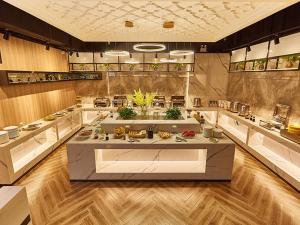 a large kitchen with a large island in the middle at Vienna Hotel Nanyang People Road in Nanyang +10 photos