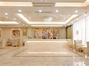 a large room with a large painting on the wall at Vienna Hotel Jiefang East Road in Wuxi