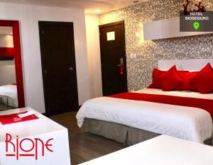 a hotel room with two beds with red pillows at Rioné Hotel Boutique in Cuenca