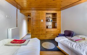 een kamer met twee bedden en een stoel erin bij The Land Beyond in Vitsa