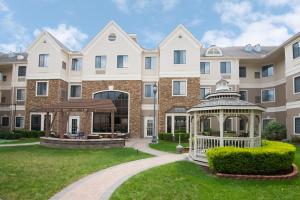 a large apartment building with a gazebo at Staybridge Suites Columbus-Airport by IHG in Columbus