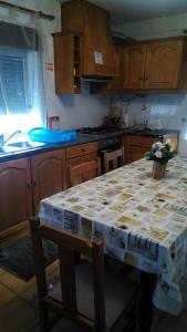 a kitchen with a table with a table cloth on it at Casa das Lezírias in Unhais da Serra