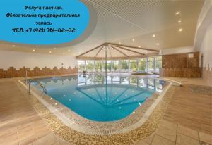 a large swimming pool in a large building at База отдыха "Черные камни" Коттеджи in Ruskeala