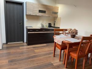 弗里代克－米斯泰克的住宿－格言酒店，一间带木桌的厨房和一间餐厅