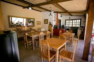 a dining room with wooden tables and chairs at Pouso do Bichinho 1 in Bichinho