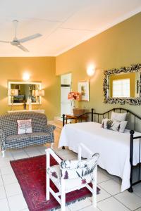 a living room with a bed and a couch at Bella's B&B in Vryheid