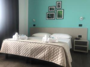 Postel nebo postele na pokoji v ubytování Hotel Palazzo Caveja