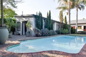 a swimming pool in front of a house at Bella's B&B in Vryheid