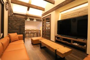 a living room with a large flat screen tv at スマートステイ大室山3合目 in Futo