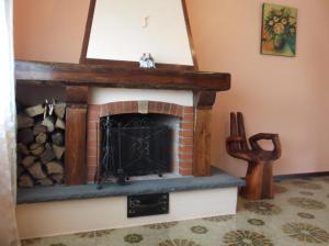 a fireplace with a mirror on top of it at La Valle dell'Etna in Zafferana Etnea