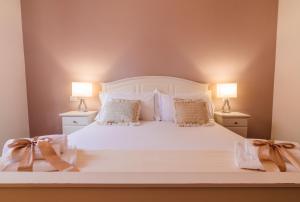 Voodi või voodid majutusasutuse Arcobaleno Suites toas