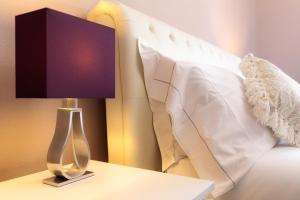 Voodi või voodid majutusasutuse Arcobaleno Suites toas