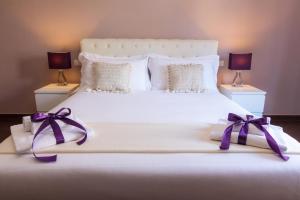 Voodi või voodid majutusasutuse Arcobaleno Suites toas