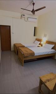 a bedroom with two beds and a ceiling at Thyme Guest House in Palolem +8 photos