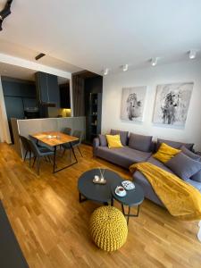 a living room with a couch and a table at DOM Boutique Apartments - Park View in Belgrade