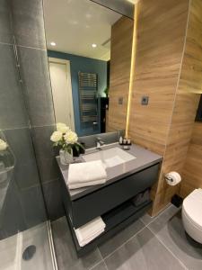 a bathroom with a sink and a toilet at DOM Boutique Apartments PARK VIEW in Belgrade +64 photos