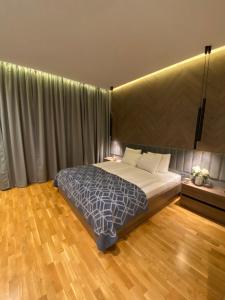 a bedroom with a large bed and a wooden floor at DOM Boutique Apartments PARK VIEW in Belgrade