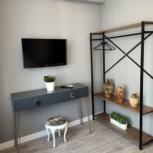 a room with a black dresser with a tv on a wall at Basilica Guest House in Istanbul