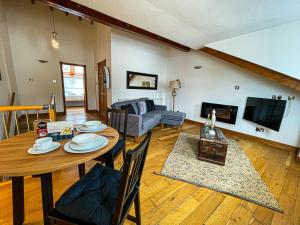 a living room with a table and a couch at Harbourside Apartments in Portpatrick