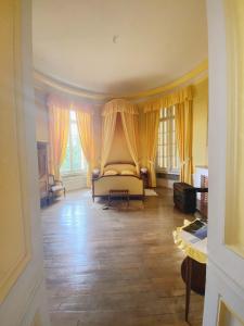 a living room with a couch and windows at B&B Chateau de Villersexel in Villersexel