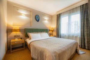 A bed or beds in a room at La Palace Exclusive Design