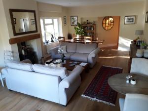 a living room with a white couch and a table at Sunny Nest in Bourton on the Water