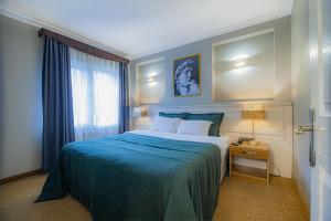 A bed or beds in a room at La Palace Exclusive Design