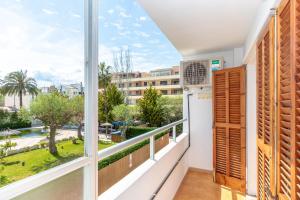 a balcony with a view of the city at Apartment Almirall in Puerto Pollensa By homevillas360 in Pollença