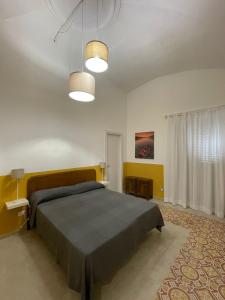 a bedroom with a large bed and two lights at L'Armonia in Gaeta
