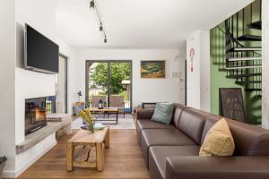 a living room with a couch and a fireplace at Modern Alpine Monsalbius Chalet in Baške Oštarije