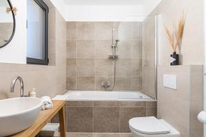 a bathroom with a tub and a toilet and a sink at Modern Alpine Monsalbius Chalet in Baške Oštarije +60 photos