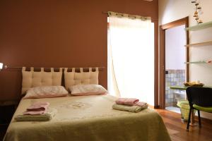 a bedroom with a bed with two towels on it at B&B Le Casette Di L&ugrave; in Agrigento