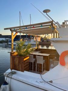 een boot met een tafel en stoelen op het water bij Exceptionnel bateau maison reine mathilde in Ouistreham