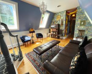 a living room filled with furniture and a large window at Merrill House in Picton