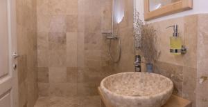 a bathroom with a shower with a bath tub at Pensiunea NEST in Dunavăţu de Jos +98 photos