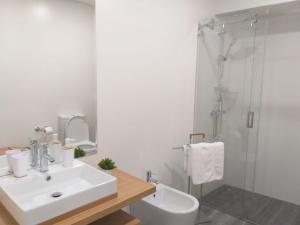 a bathroom with a sink and a shower at Casa das Ondas in Ribeira Grande