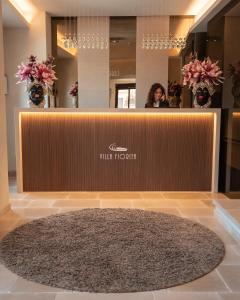 a woman standing behind a counter in a salon at Villa Fiorita Boutique Hotel in Taormina +104 photos