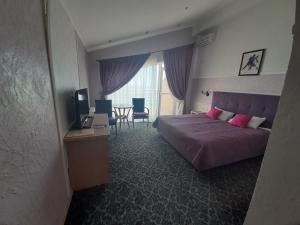 a bedroom with a bed and a television and a table at Villa Lavanda in Vapnyarka +36 photos