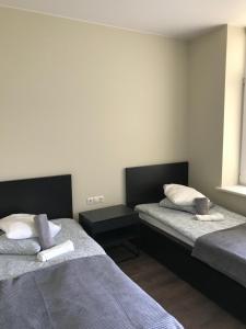 Säng eller sängar i ett rum på Hotel Akmenė