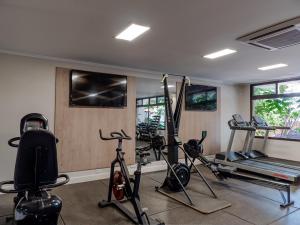 a gym with bikes and tread machines in a room at Hotel Saint George in Puerto Iguazú