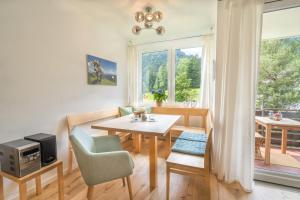 een woonkamer met een tafel en stoelen en een raam bij Ferienwohnung Wanderbar in Oberstdorf