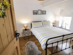 a bedroom with a bed and a dog on the floor at The Toll House in Dolgellau