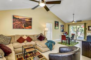a living room with a couch and a table at Orchid Tree Villa Permit# 2244 in Palm Springs