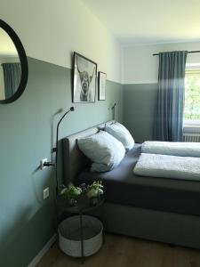 a small bedroom with a bed and a mirror at Haus zur lachenden Lieselotte in Postbauer-Heng