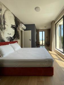 a bedroom with a bed with a large painting on the wall at Buena Vista Villas in Varna City +105 photos