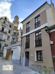 a white building with a clock tower in the background at Ibañez 3 in Ribadeo
