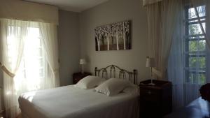 Ένα ή περισσότερα κρεβάτια σε δωμάτιο στο Pazo Cibrán