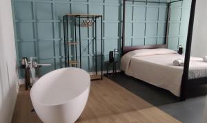 a bedroom with a bed and a table and a sink at Panoramica dei Templi B&B in Agrigento